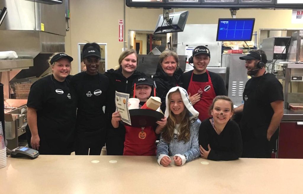 Carlie celebrates with Arby's team members